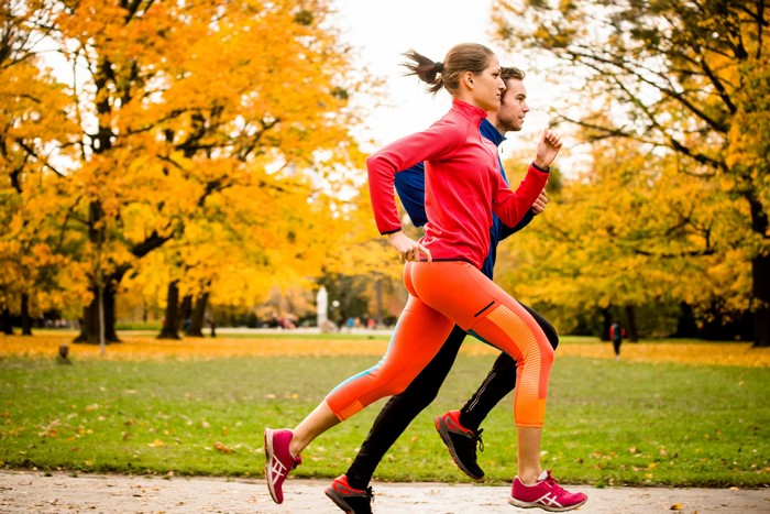 Couple running in autumn park