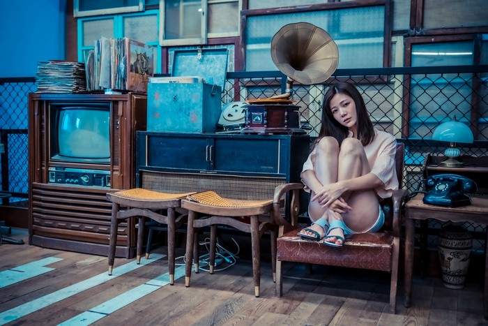 4K Asian Woman Sitting on Armchair with Vintage Items