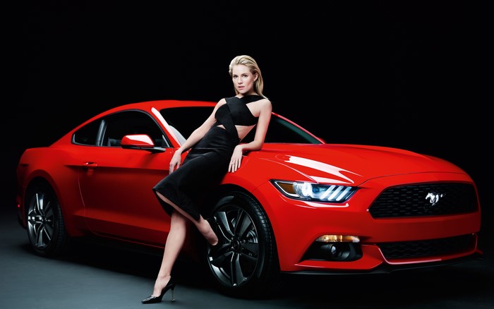 Sienna Miller posing with a red Ford Mustang GT500
