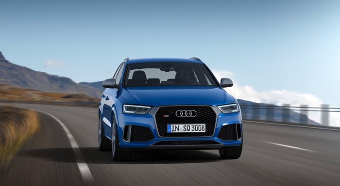 Blue Audi RS Q3 Quattro driving on a mountain road