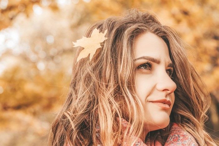 Woman with autumn leaf in her hair