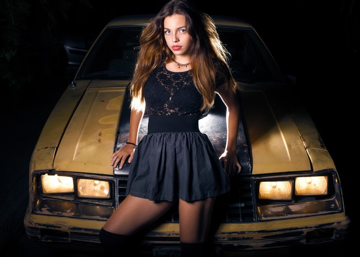 Woman leaning on a vintage car