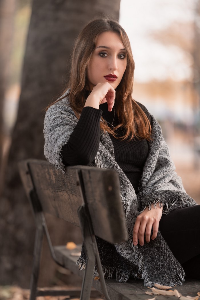 Alessia sitting on a bench with a scarf