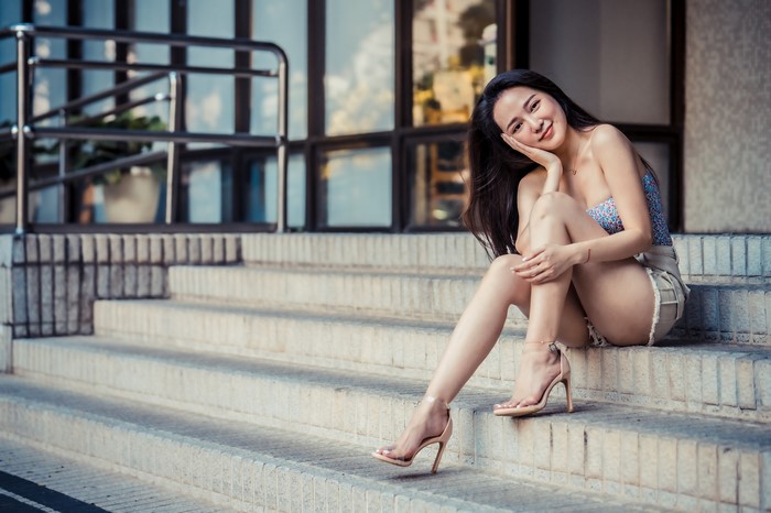 4K Asian Woman Sitting on Stairs Smiling