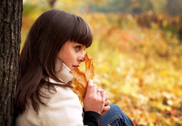 Woman holding a leaf in autumn