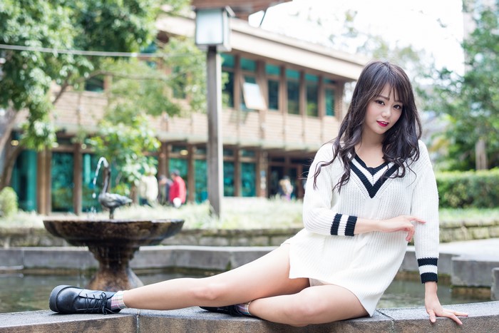 4K Asian Woman Sitting in White Sweater