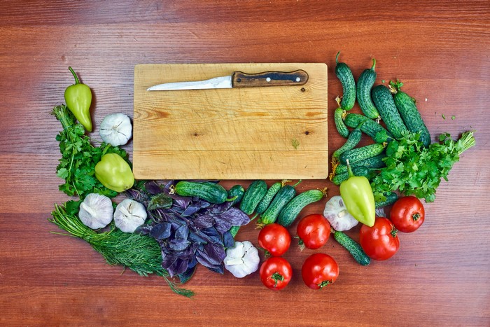 Vegetables and knife on a cutting board
