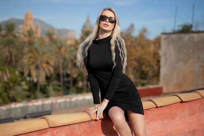 Ekaterina Enokaeva wearing a black dress and sunglasses