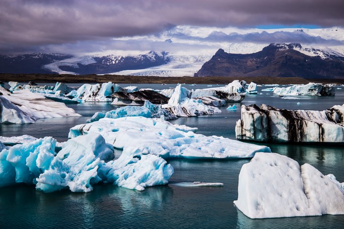 Icebergs in Iceland with Mountains and Clouds