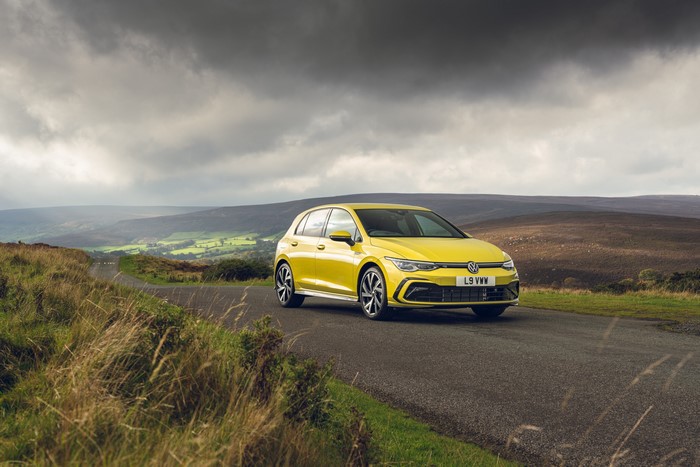 Yellow Volkswagen Golf eTSI R-Line on UK Road
