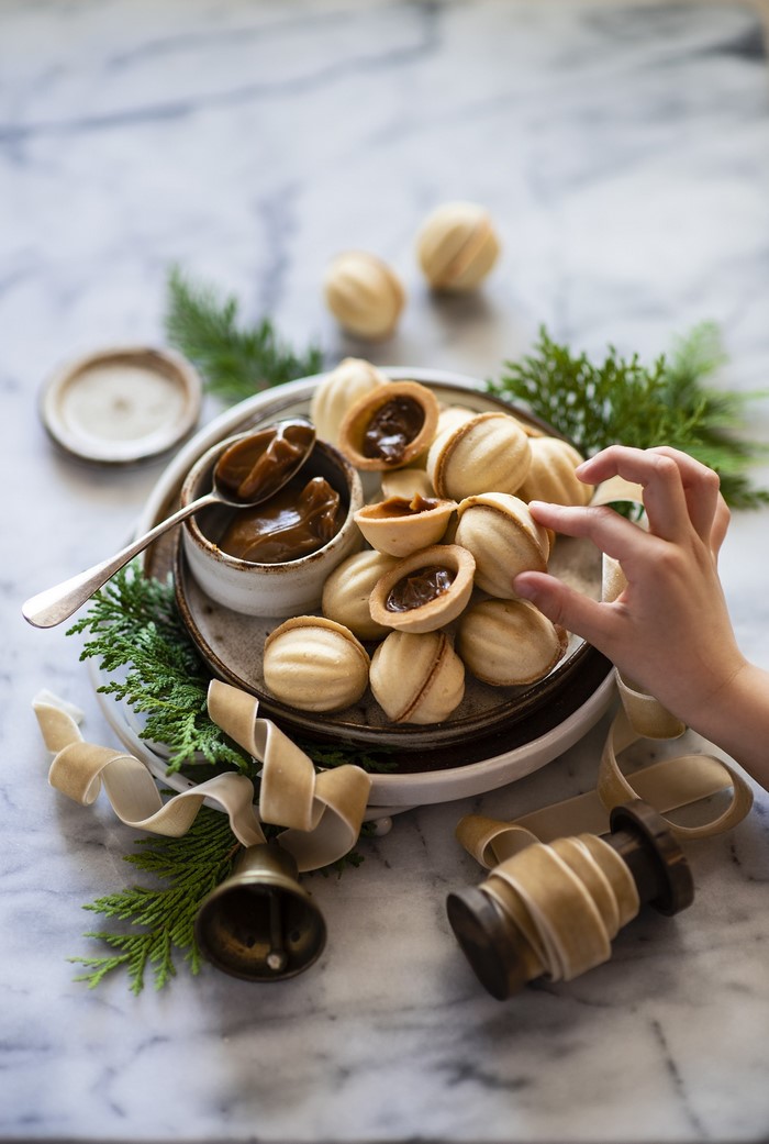 Sweet nut-shaped pastries with caramel filling and festive decor
