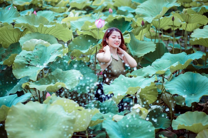 Asian woman in lotus pond