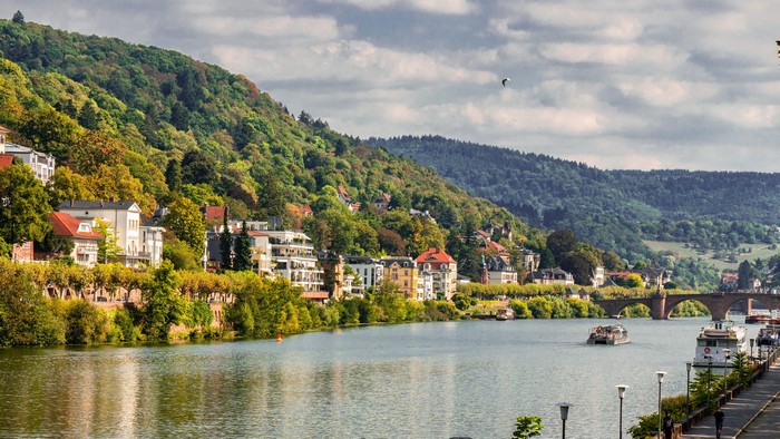 River with boats and bridge in Heidelberg, Germany