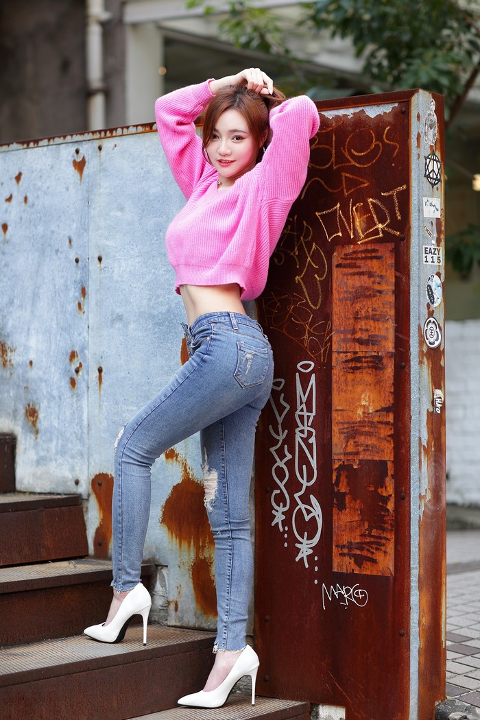Asian Woman in Pink Sweater and Jeans Pose