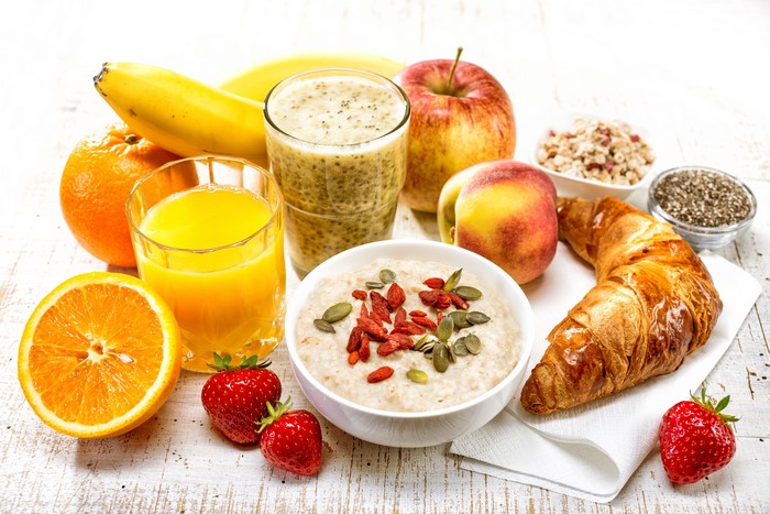 Healthy Breakfast with Fruits, Oatmeal, and Croissant