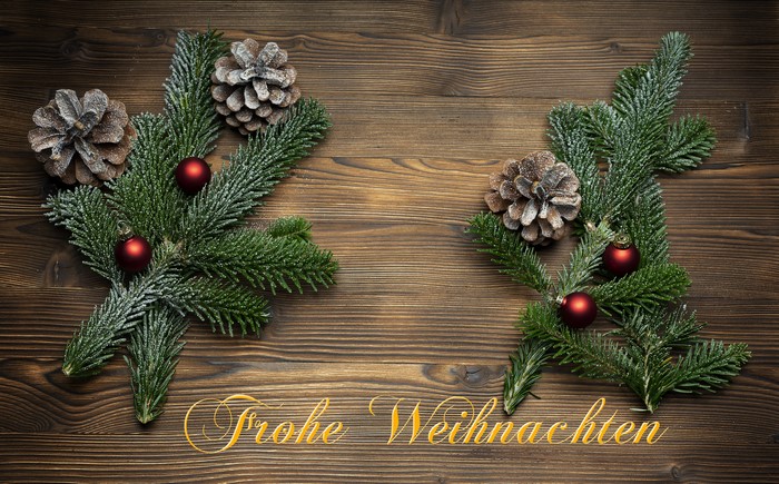 Christmas Branches with Pine Cones and Ornaments on Wood