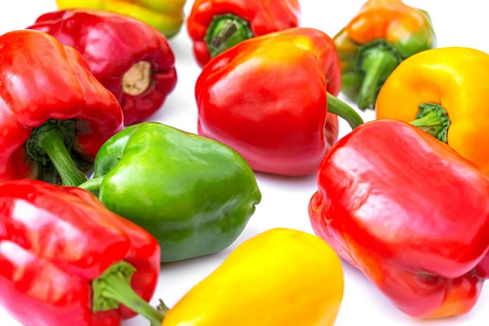 Assortment of colorful bell peppers on a white background