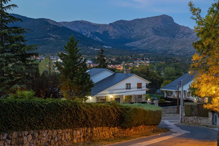 Houses in Navacerrada, Spain at Evening with Mountains