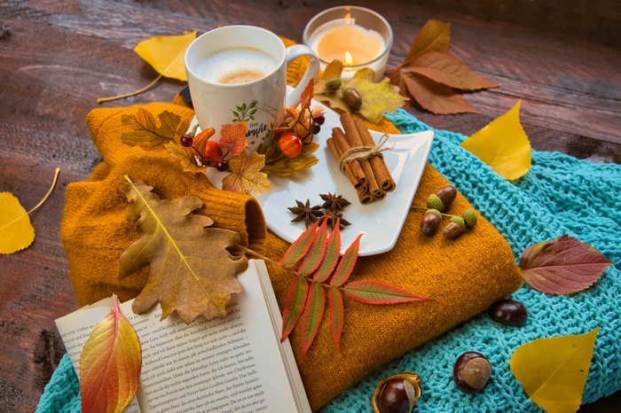 Autumn still life with coffee, book, and cinnamon
