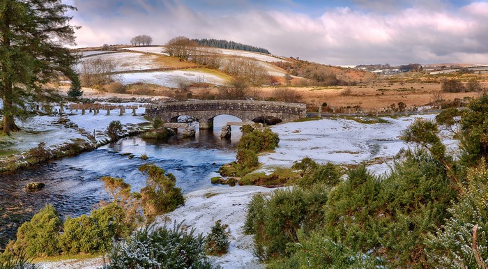 Stone bridge over a river with snow in England