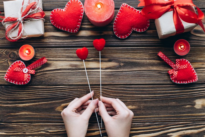 Valentine's Day gifts and candles on wood