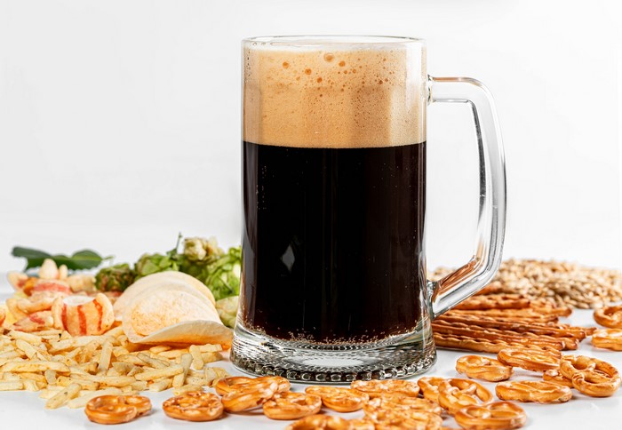 Beer mug with snacks and hops