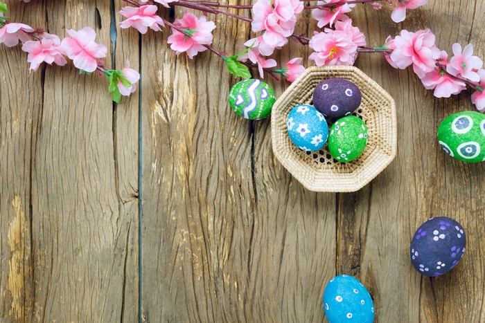 Easter Eggs and Pink Flowers on Wood Planks