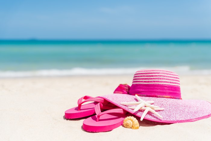 Summer Hat and Flip-flops on a Beach