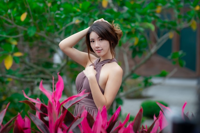 Asian woman in a dress posing outdoors