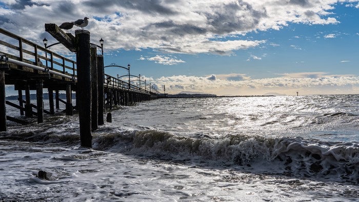 Wooden Pier and Ocean Waves in White Rock, Canada