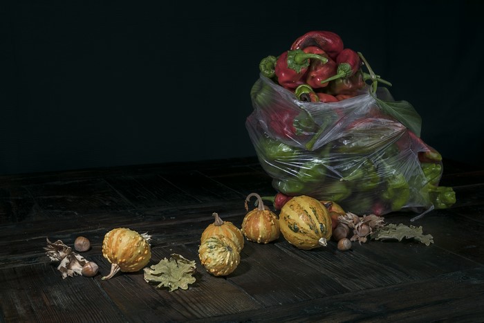Bell peppers and pumpkins on a wooden table