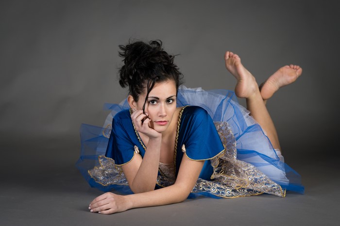 Martina lying down in a blue dress