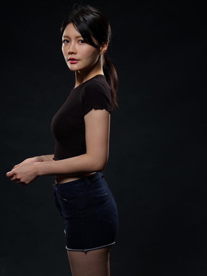 Asian girl in black top and denim shorts
