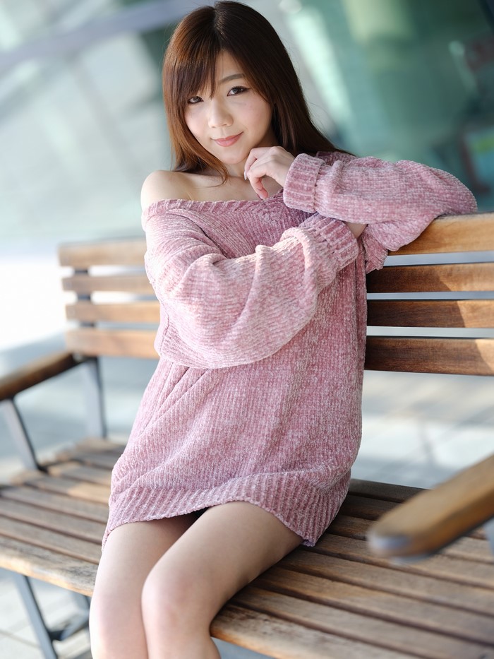 Asian Woman Sitting on Wooden Bench Wearing Sweater
