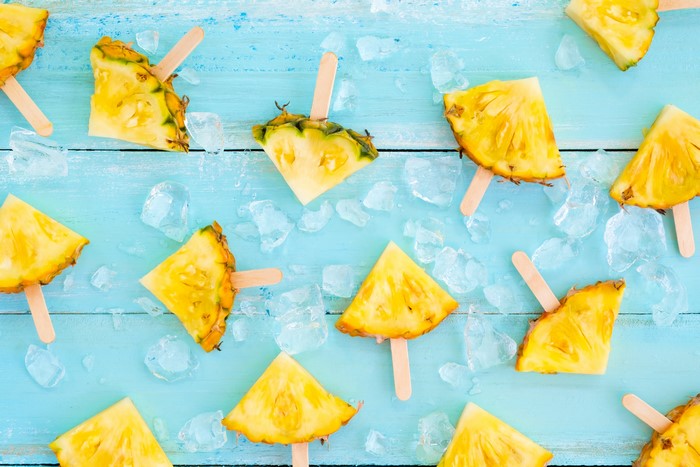 Pineapple slices on sticks with ice