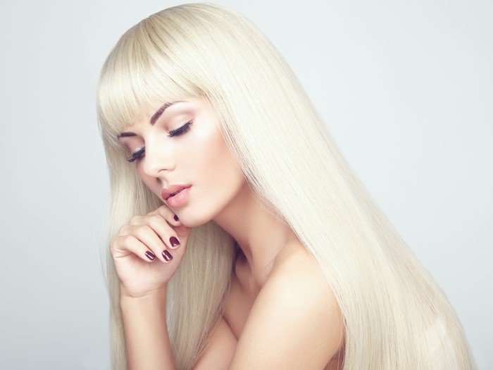 Blonde girl with bangs and long hair, manicure