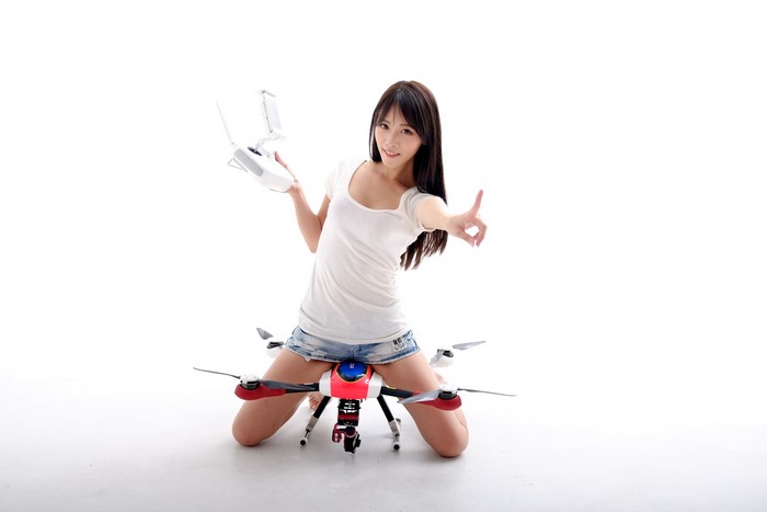 Asian woman with drone remote and quadcopter