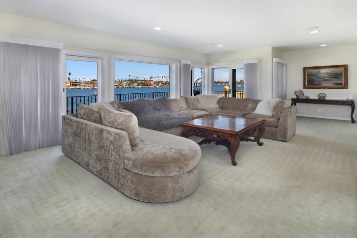 Living room with sectional sofa and water view