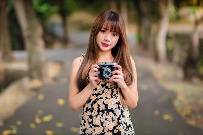 Asian woman holding a vintage camera