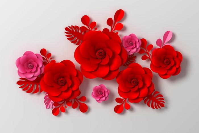 Red and pink paper flowers on gray background