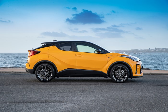 Yellow Toyota C-HR Hybrid GR Sport crossover parked by the sea