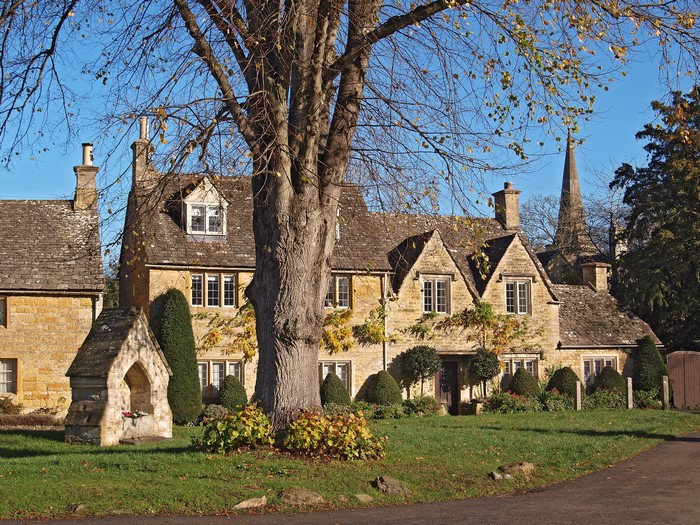 Village houses and church spire in Lower Slaughter, England