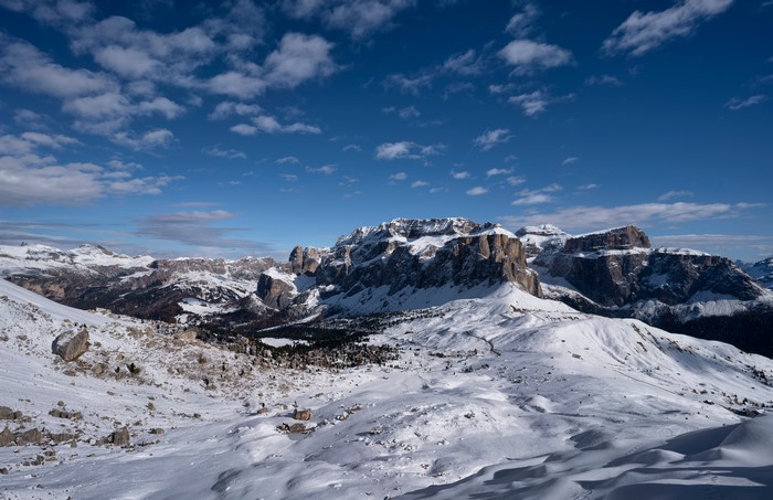 Snowy Dolomites Mountains in Italy under a Cloudy Sky