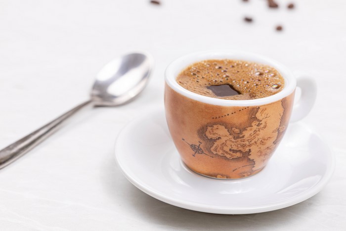Espresso cup with map design and spoon