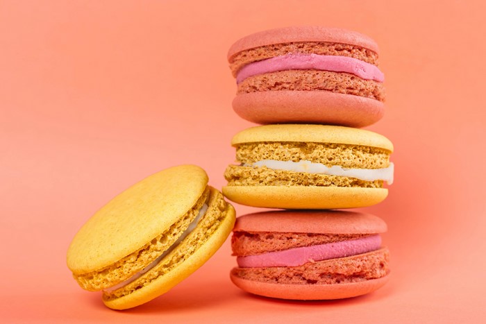 Stack of Colorful Macarons on Pink Background