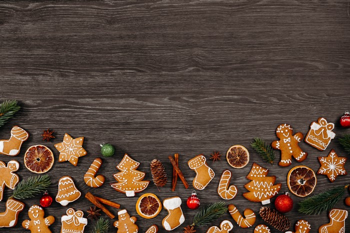 Christmas gingerbread cookies and decorations on dark wood