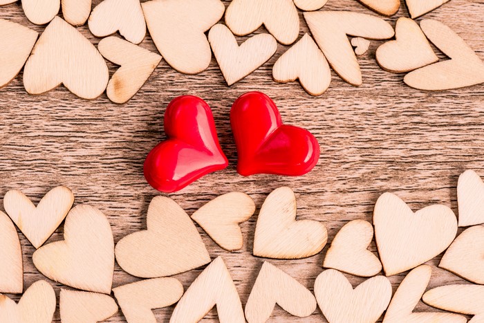 Two red hearts and many wooden hearts