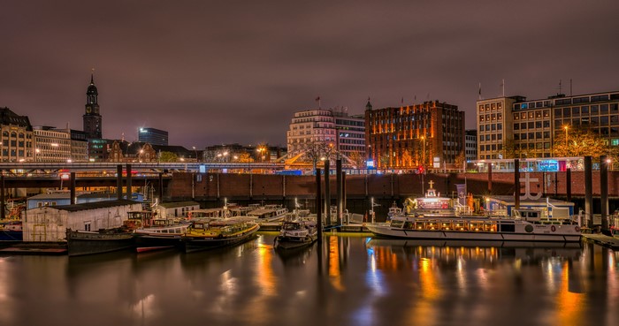 Hamburg Marinas at Night with Riverboats and City Skyline