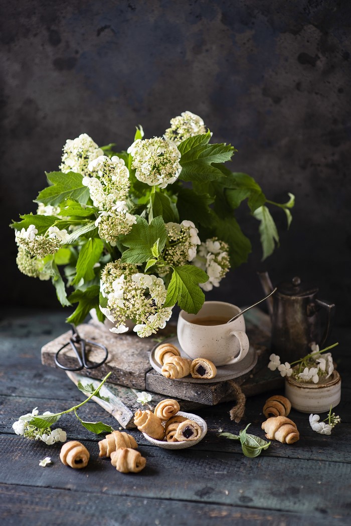 Still life with white flowers and croissants