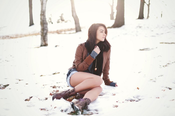 Katie Joanne sitting in the snow wearing a jacket